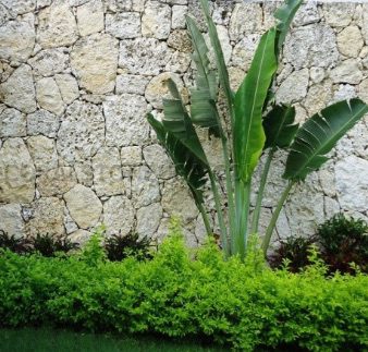 A stone wall that serves as exterior inspiration for Turks and Caicos real estate at The Strand.