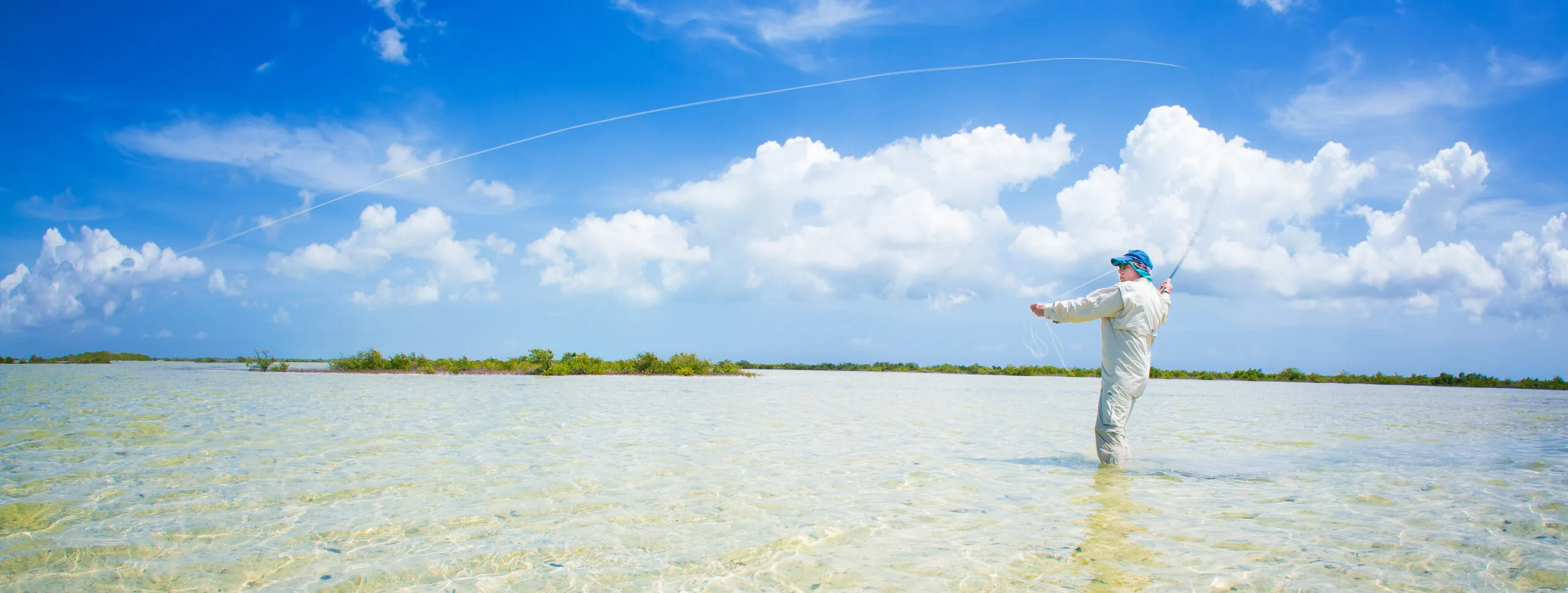 Man in shallow water bonefishing in Turks and Caicos from The Strand